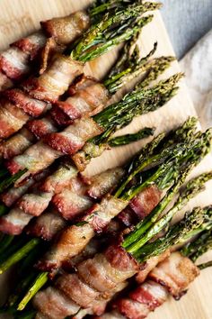 bacon wrapped asparagus on a cutting board