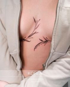 a woman's chest with flowers on it and the word korea written in black ink