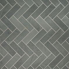 a tile floor with grey and white herringbones on the top, in an angled pattern