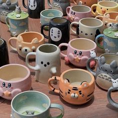 many different colored mugs with cats on them