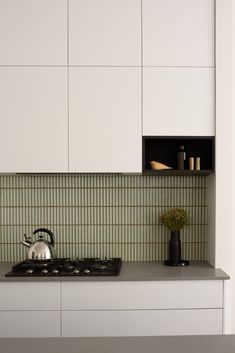 a stove top oven sitting next to a white cupboard