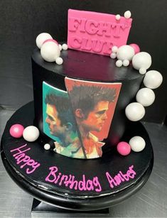 a birthday cake with an image of two men on it