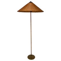 a floor lamp with a brown shade on it