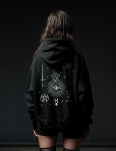 Invoke your inner mystic with The Magician Tarot Hoodie. As the temperatures drop, let this cotton/polyester blend hoodie be your warm embrace, merging practical warmth with spiritual symbolism. Channel the power of manifestation, self-confidence and alchemy with this easy addition to your daily wardrobe. + Printed on Lane Seven LS14001 Premium Unisex Pullover Hoodie + 80% cotton/20% polyester fabric for all day coziness + Up to 3XL available with classic loose fit for all body types + Tear away Gothic Winter Hoodie With Graphic Print, Gothic Graphic Print Winter Hoodie, Winter Gothic Hoodie With Graphic Print, Gothic Hoodie With Graphic Print, The Magician Tarot Card, Hoddies Outfits, Magician Tarot Card, Magician Tarot, The Magician Tarot