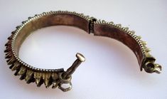 "VINTAGE ANTIQUE COLLECTIBLE TRIBAL OLD SILVER SPIKED HINGE BRACELT OR BANGLE PAIR FROM RAJASTHN INDIA, USED BY TRIBAL PEOPLE OF RAJASTHAN INDIA. GREAT HANDMADE DESIGN, GOOD FOR TRIBAL STYLE BELLY DANCE OR FOR ETHNIC JEWELRY COLLECTOR. Inner Diameter - 4.7 cm(1.85\") Inner circumfernce - 14.75 cm(5.8\") Outer Diameter - 6.2 cm(2.44\") Width - 1.1 cm(0.43\") Weight for pair - 125 grams Material - Good silver & original old worn pair." Ornate Oxidized Cuff Bracelet Bangle, Ornate Oxidized Bangle Cuff Bracelet, Handmade Ornate Metal Bangle, Ornate Handmade Metal Bangle, Engraved Metal Bangle For Festivals, Traditional Metal Bangle Cuff Bracelet, Ornate Handmade Bangle For Festivals, Handmade Ornate Bangle For Festivals, Antique Oxidized Bangle For Festivals