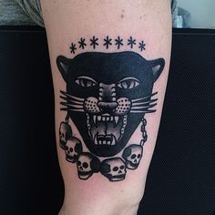 a black cat with skulls on it's leg