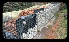 a pile of bricks sitting next to a wire fence