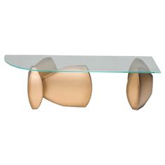 a glass and metal coffee table with an abstract design