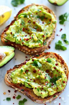 two pieces of bread with avocado spread on them