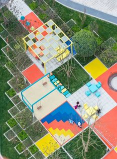 an aerial view of colorful playgrounds in the park