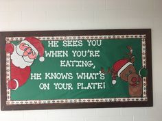 a green sign with santa clause and reindeer on it that says he sees you when you're eating, he knows what's on your plate