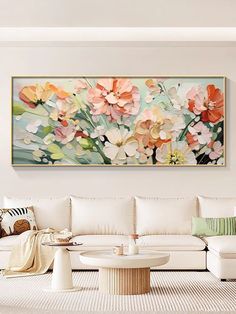 a living room filled with furniture and a large painting on the wall above it's coffee table