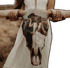 a cow skull with an image of a man and woman kissing on it's back