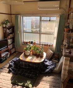 a living room filled with furniture and a flat screen tv sitting on top of a wooden table