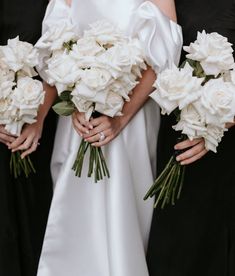 the bridesmaids are holding bouquets of white flowers