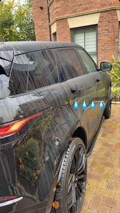 a black car with blue rain drops on it