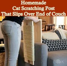 a woman standing next to a cat scratching post on top of a couch in a living room