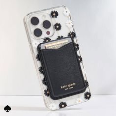 an iphone case with flowers on it and a card holder attached to the back cover