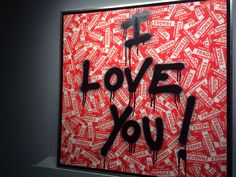 a painting with words written on it that says i love you in black and red