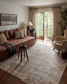 a living room filled with furniture and a large rug