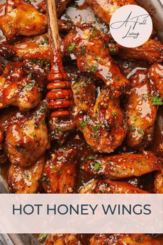 honey chicken wings in a pan with a wooden spoon and text overlay that reads hot honey wings