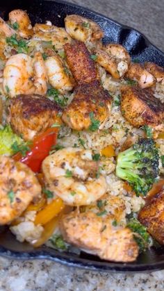 shrimp, broccoli, and rice dish in a black bowl on a counter