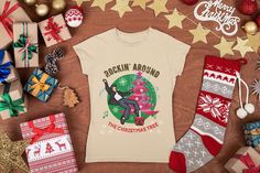 A colorful rock 'n' roll Christmas tree shirt featuring a retro rockabilly dude dancing around a stylized pink Christmas tree. Order the size you would typically wear in a standard, normal fitting t shirt. If you are between sizes, or just like a looser fit, you may want to order a size up. This classic unisex jersey short sleeve tee fits like a well-loved favorite. Soft cotton and quality print make users fall in love with it over and over again. These t-shirts have-ribbed knit collars to bolster shaping. The shoulders have taping for better fit over time. Dual side seams hold the garment's shape for longer.  .: 100% Airlume combed and ringspun cotton (fiber content may vary for different colors) .: Light fabric (4.2 oz/yd² (142 g/m .: Retail fit .: Tear away label .: Runs true to size Se Roll Christmas Tree, Rock And Roll Music, Christmas Tree Shirt, Rock N Roll Music, Rock N’roll, Pink Christmas Tree, Tree Shirt, Pink Christmas, Christmas Shirt