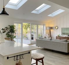 an open kitchen and living room with skylights