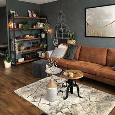 a living room filled with furniture and lots of plants on the shelves in front of it