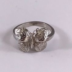 Dainty solid sterling silver, gold or platinum butterfly ring. Perfect for ladies or girls. This pretty butterfly comes in solid sterling silver, 10k, 14k or 18k gold or in platinum. If you choose gold for your ring, you can choose regular gold, white gold, rose gold or green gold (green in 14k or 18k only). Silver and platinum only come in the standard silver color. While puzzle rings are our specialty, we offer a wide range of non-puzzle rings and other jewelry in a variety of motifs. We carry Puzzle Rings, Puzzle Ring, Pretty Butterfly, Butterfly Ring, Midi Rings, Green Gold, Gold Rose, Green And Gold, Silver Color