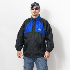 "Vintage Adidas windbreaker in blue-black with white logo on the chest - 2 outer pockets - with a front zip - lined - hood hidden in the collar - material: 100% polyester SIZE size from label: D7, US L, GB 42/44, F 186 best fits men: L MEASUREMENTS chest: 52 inches (132 cm) length: 28 inches (71 cm) sleeve length from armpit: 21,5 inches (55 cm) The model is 6'1\" (186 cm), measures 41-35-39 (104-88-100 cm) and typically wears clothing in size L CONDITION - 8/10 - Good vintage condition. The zip Urban Blue Windbreaker With Double Hood, Urban Blue Windbreaker With Double-lined Hood, Blue Windproof Outerwear For Streetwear, Weatherproof Blue Outerwear For Streetwear, Blue Sporty Windbreaker With Fleece Lining, Blue Waterproof Streetwear Outerwear, Blue Waterproof Outerwear For Streetwear, Sporty Black Windbreaker With Fleece Lining, Black Sporty Windbreaker With Fleece Lining