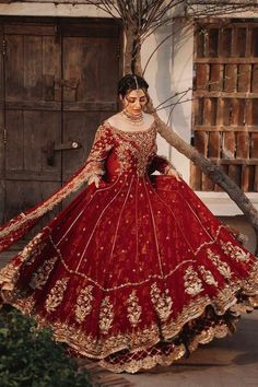 a woman in a red and gold wedding gown