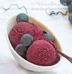 two scoops of blueberry ice cream in a bowl