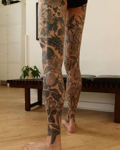 a woman's legs with tattoos on them