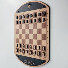 a wooden chess board mounted to the wall