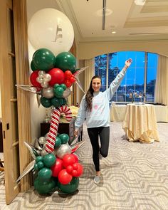 a woman is standing in front of some balloons