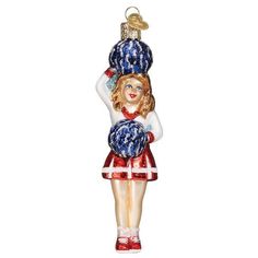 a glass ornament with a girl in red, white and blue dress holding a ball