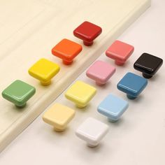 there are many different colors of magnets next to each other on the counter top