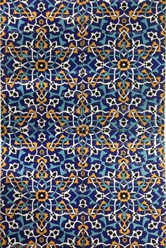 an intricate blue and orange pattern on fabric