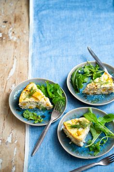 three plates with slices of quiche on them