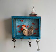 a blue shelf with keys and a chicken in the middle on it's side