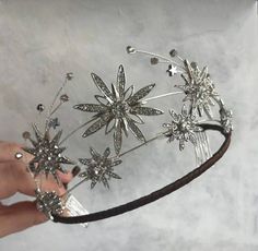 This tiara is beautifully silver-plated and encrusted with sparkling clear genuine zirconium stones of various sizes in Star shapes. The many zirconium Stones make this crown sparkle in any light and are prong set by hands! This piece is versatile and compliments many different styles, can be worn for Weddings, Bridal Showers, Birthdays, Baby Showers, Graduation, Maternity Shoots or any special occasions! Handmade Star and CelestialTiaras/Crown Made to Order Diamond Weight -- 14.64ct Diamond -- Celestial Bride, Pretty Wedding Rings, Handmade Tiaras, Beautiful Hair Accessories, Crown Tiara, Diamond Crown, Zircon Jewelry, Sterling Silver Brooch, Hair Accessories Jewelry