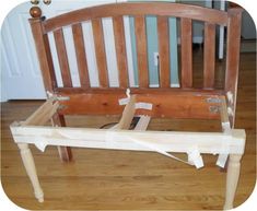 a wooden bench sitting on top of a hard wood floor