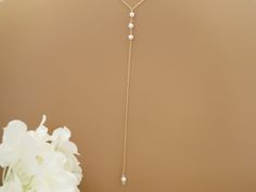 Accentuate your low back gown with this dainty pearl backdrop necklace. A single 8mm Swarovski pearl in front compliments the 6 inch back drop which includes a linear 3 pearl mid back design. Measures 26 inches in diameter and fits over the head, if your wedding look requires an updo hairstyle make sure to place the necklace on first. The back drop detail measures 6 inches in length. Chain offered in either 14kt. Gold filled, Rose Gold or Sterling silver. Wedding photo provided by Ben Cross Phot Adjustable Pearl Backdrop Necklace For Wedding, Minimalist Wedding Backdrop Necklace With Adjustable Chain, Minimalist Adjustable Backdrop Necklace For Wedding, Dainty Adjustable Backdrop Necklace For Wedding, Adjustable Lariat Necklace With Pearl Charm For Wedding, Minimalist Lariat Backdrop Necklace For Wedding, Minimalist Wedding Backdrop Necklace With Delicate Chain, Delicate Adjustable Pearl Chain Backdrop Necklace, Adjustable Pearl Pendant Backdrop Necklace For Wedding