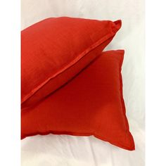 two red pillows sitting on top of each other