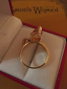 "This is a very unique piece of vintage jewelry. This 14K two tone Citrine and diamond ring is shaped like a \"V\". The stone points downward to grace ones finger. The pear shaped Citrine measures 9x7mm and it's flanked by a white gold plate, holding 5 small diamonds. There is a tiny chip on the side of the stone, which I could feel when I ran my finger across it. However, I can't see it without a loupe. Depending on the light, it can look yellow, gold, or an orangy color. It's a size 6 3/4, and Unique Yellow Gold Topaz Ring For Formal Occasions, Pear-shaped Topaz Ring For Formal Occasions, Formal Teardrop Topaz Rings, Unique Formal Topaz Ring, Formal Pear-shaped Citrine Ring, Formal Pear-shaped Topaz Ring, Unique Gold Topaz Ring For Formal Occasions, Formal Yellow Gold Topaz Teardrop Ring, Formal Pear-shaped Topaz Ring Fine Jewelry