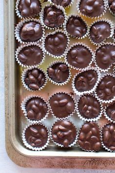 chocolate peanut clusters in a baking pan with the words dark chocolate peanut clusters