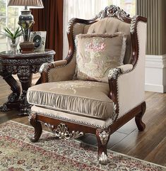 a living room with a chair, table and lamp