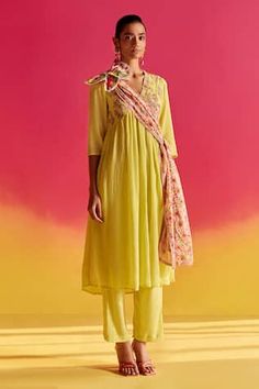 Yellow V-neck kurta with embroidered yoke and placket, and pockets Paired with classic URI straight pants and a floral dupatta finished with crochet lace.
Components: 3
Pattern: Embroidered
Type Of Work: Floral
Neckline: V Neck
Sleeve Type: Three-quarter
Fabric: Organic fabric
Color: Green
Other Details: 
Length:
Kurta: 46 inches
Sleeve: 17 inches
Model Height: 5ft 9inches, wearing size XS
Note: Floral Patch shown in the image is not for sale.
Occasion: Mehendi and Haldi - Aza Fashions Fitted Salwar Kameez With Embroidered Border For Spring, Spring Pista Green Set With Embroidered Border, Spring Resham Embroidery Salwar Kameez, Pista Green Dupatta With Embroidered Border For Spring, Spring Pista Green Dupatta With Embroidered Border, Semi-stitched Anarkali Set With Embroidered Border For Spring, Spring Semi-stitched Anarkali Set With Embroidered Border, Traditional Festive Kurta With Yoke Detail, Traditional Yoke Kurta For Festive Season