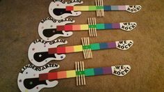 there are many different colored forks on the floor with stickers that say we rock